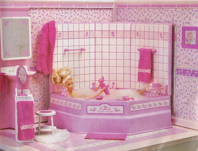 Barbie lounges in a pink tiled bubblebath in a room with pink floral wallpaper and pink furniture and accessories